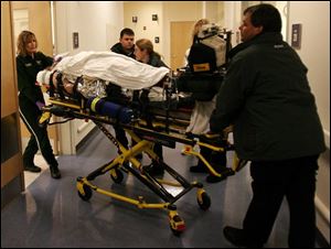 Personnel from Promedica Air wheel an accident victim into the emergency room at Toledo Hospital in West Toledo.
