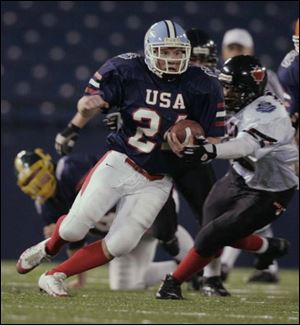 Lake's Dan Tarver carries against a bigger and more experienced defending champion Canadian team which shut out all of its opponents.