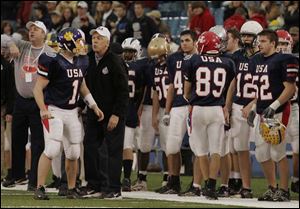 Coach Dick Cromwell gives some advice to Bryan quarterback Jamie Lorentz.