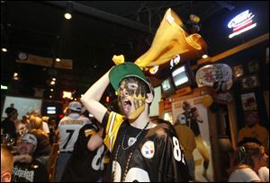 Dylan Valenti, 13, celebrates a play by the Pittsburgh Steelers, led by his favorite player, Findlay's Ben Roethlisberger.