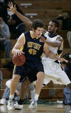 Kent s Kevin Warzynski charges into UT s Jerrah Young, who sparked the Rockets in the first half on both ends of the court.