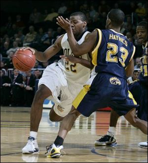 Toledo's Keonta Howell is fouled by Kent State's DeAndre Haynes as he drives to the basket in the second half. Howell had nine points. He was 2-for-2 from 2-point range and 5-for-5 from the free-throw line, but was 0-for-2 from beyond the 3-point arc.