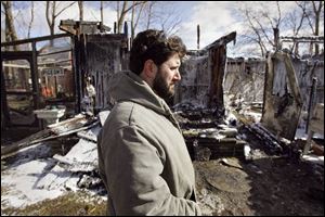 Rick Evola, co-owner of Nature s Creek Petting Zoo, surveys the remains of a building that
was destroyed by a blaze that killed a third of the animals in the privately owned zoo.
