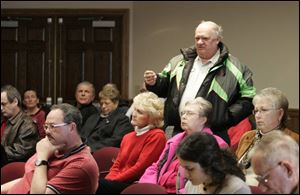 Jim Cook, owner of Jim's Snowmobile Sales, speaks against a proposed 0.5 percent county sales tax during a Henry County commissioners' public hearing in Napoleon. 