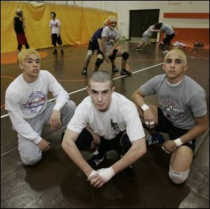 Erik Mayer is right in the middle of Southview's wrestling success. Kevin Hijioka, left, and Gabe Garcia, right, also have outstanding records for the Cougars.