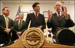 Thomas Charles, right, discuss the indictments as Howard Hudson, far left, Arnie Schropp, and Prosecutor Ron O Brien listen.
