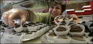 Lisa Blade packs a heart box at Superior Chocolates at Westgate.