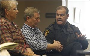 Henry County Clerk of Courts Judy Sonnenberg, left, and Steve Roby listen to Sheriff John Nye, right, during a public hearing on a proposed sales tax, which voters had repealed in November. 
