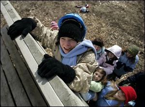 Woodmore Elementary School student Kayla Beam, 11, gets a boost from her classmates as she tries to scale a wall at Camp Michindoh near Hillsdale. The sixth graders worked on teamwork and outdoor studies during their week-long camp. 