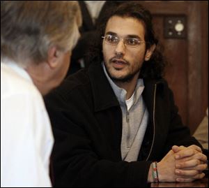 President Daniel Johnson listens to student Emad Abouarab. 'Being Arab right now seems to be like a crime,' Mr. Abouarab said. 'I feel we are defending ourselves because we are Arab.'
