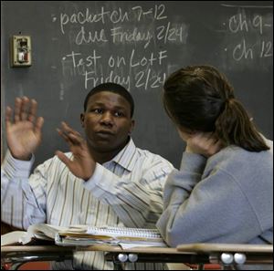 Greg Owens tutors Central Catholic junior Alexa Villegas on her honors chemistry homework. Mr. Owens has degrees in economics and premed from Yale University, but he decided to stay in Toledo and start a tutoring business, preparing students for the SAT and ACT. 'Everyone who wants to do well and have a successful life, college is where it starts,' he says. IN THE PUBLIC EYE