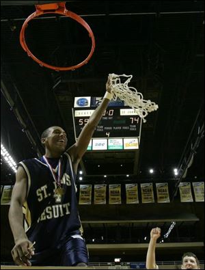 St. John's Jonathan Dunn displays the net after the Titans cut down the Scott Bulldogs last night at Savage Hall.