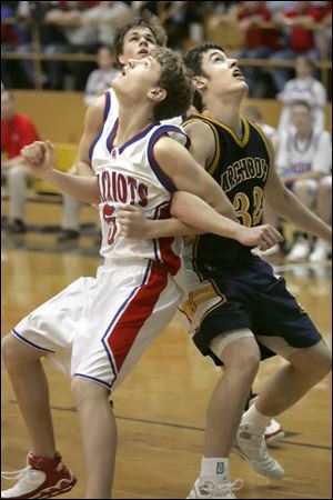 Patrick Henry's Kyle Tietje, left, and Archbold's Gene Goering go elbow-to-elbow as they wait for a rebound.