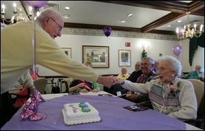 Frieda Grund, right, thanks piano player Dick Schmidt for playing at a party for her at Swan Creek Retirement Village.

