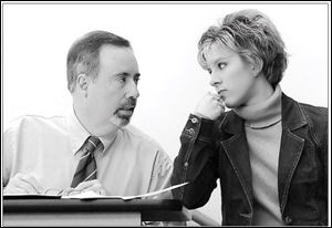 Adviser Gary Schiefer, associate professor of business, confers with club president Laura Kirdendall. 