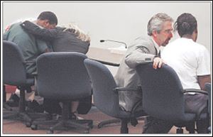 Devan Fields, far left, and Catherine Varner, far right, talk with attorneys Ann Baronas and Martin Goff. The two are accused of plotting to kill Ms. Varner's mother and her younger brother.