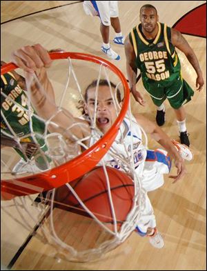 Jai Lewis can only watch as Florida's Joakim Noah scores two of his 12 points from very close range in last night's national semifinal. Noah also had eight rebounds and blocked four shots.
