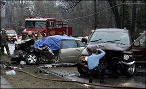Emergency crews investigate a fatal accident on Secor Road south of Laskey Road.
