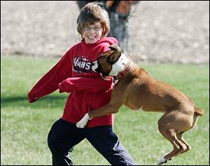 the blade/dave zapotosky Andrew Sergent, 11, plays with Oscar, an inspiration to the young poetry writer.