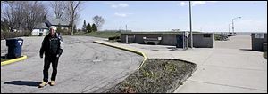 Luna Pier Mayor Ric Murray walks around the parking lot to the beach he hopes will be a cash collector for the town.