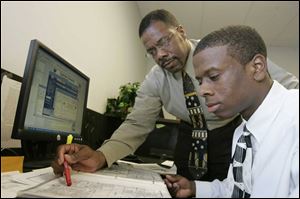 Casey Diggins, left, trains his son, Casey, Jr., to be an appraiser.