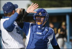 Blue Devils catcher Steve Decker gives a high-five to a teammate during a game against Northview. Decker is hitting .359. He s also done well as a relief pitcher.
