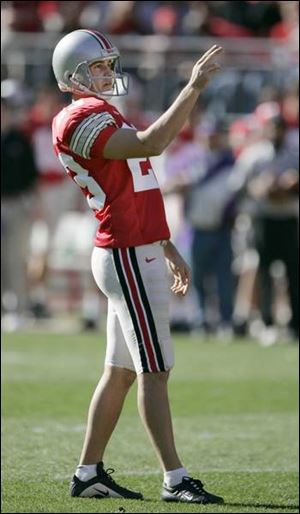 Ohio State's Josh Huston sizes up a kick against Northwestern. After hitting 22 of 28 field goal attempts for the Buckeyes, he will play golf while the draft takes its course.
