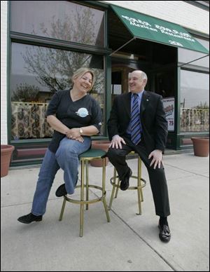 Casa Barron owner Leslie Barron, left, chats with Perrysburg Mayor Nelson Evans about a patio fence she'd like to erect.