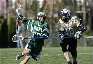 Sylvania s Brandon Stansley tries to get past St. John s defender
Todd Tolford. The Titans improved their record to 7-3.

