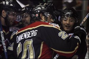 Wheeling's Eric Sonnenberg (20) congratulates Bill Downey on his second-period goal last night in an ECHL North Division final playoff game. The Storm was outshot for the first time in 37 games, 45-28, by the Nailers.