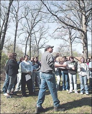 Pat O'Brien, who works for the City of Toledo Division of Forestry, speaks to students from Notre Dame Academy about tree care, invasive species, and habitat improvement.