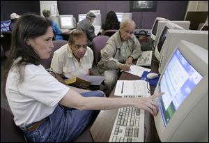 Counselor Cindee Boaz helps Jean Shipp of Far Rockaway, N.Y., and her mother, Laura Gary of Toledo, get information.