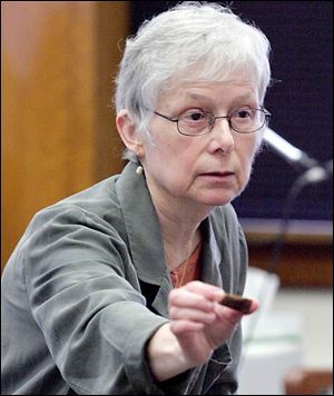 Julie Saul shows the mandible of Sister Margaret Ann Pahl.