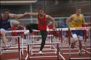 Rogers  Russell Harris, center, makes things close with Whitmer winner Mike Hyttenhove, left, in the 110-meter hurdles.
