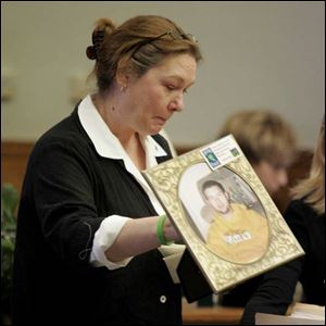 Gina Nowak shows a picture of her son, Brian Eppink II, who was fatally hurt in the crash. The driver, Sarah Karamol, was legally intoxicated.