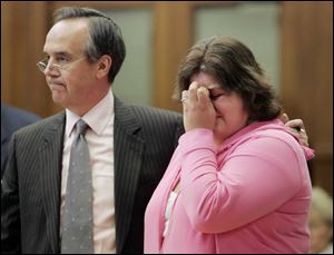 Attorney Jerome Phillips comforts Sarah Karamol, who wept as the mother of the man who was fatally injured in a car Karamol was driving made a statement in court yesterday. 