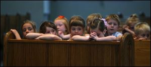 Kindergartners including, left to right, Kayla Hunter, Madisen Crites-Kline, Emily Peters and Taylor Amlin saw the statue at St. Wendelin s in Findlay.
