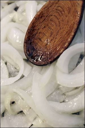 Onions are sauteed for a classic Philadelphia Cheesesteak sandwich.