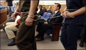 Steven Baden sits in a Lucas County Common Pleas courtroom before entering into a plea bargain on the stalking charge.