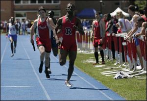 Tony Watkins anchors the Rogers 1600-meter relay team to victory in 3:23.59. The Rams were second in team scoring.