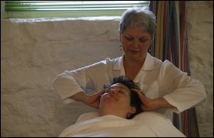 
Jan Archambeau of The Kerr House does her part in the  triple treat  massage being administered to Patty Flanagan. Laurie Hostetler, who opened The Kerr House in 1980, says the Grand Rapids, Ohio, spa has drawn people from all 50 states and many other countries.

