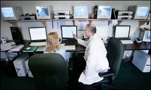 Dr. Siobhan Kuhar, left, and Dr. Raymond Bourey study patient test results at the Regional Center for Sleep Medicine. 