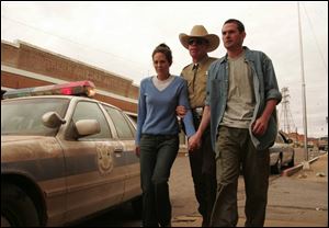 Annabeth Gish, left, Ron Perlman, and Henry Thomas in a scene from  Stephen King s Desperation. 

