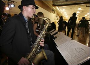 Robert Bovee, makes his sax sound sweet for Katie Greer and Jeff Hensien.