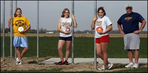 The Pendleton sisters at Woodmore practice at school and at home, where they have their own throwing ring. Mike Pendleton
instructs his daughters, from left, Carly (seventh grade), Erin (freshman) and two-time state champion Emily (junior).