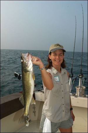Laura Jones, who works on the staff of the Ohio Department of Natural Resources, displays a hefty Lake Erie walleye.