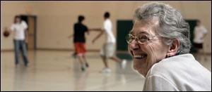 Pat Seeholzer, who is retiring, officiates a kickball game in the gym.