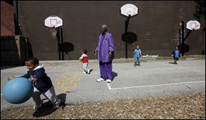 Foster grandparent Annie Bell Rayford plays with Lamar Johnson, 3.