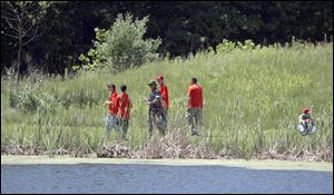 Students explore a pond at the Rieck Center, which boasts prairies, woodlands, wetlands, and diverse wildlife.