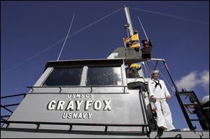 Cadet Justin Bair, 16, of Perrysburg, gets a chance to view the activity in port from the bridge of the Grayfox.
